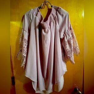 Elastic neckline sleek top with 3/4 length lace bell sleeves.  Dressy or casual